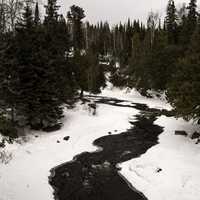 Cascade river winding through the forest in the winter at Cascade River State Park, Minnesota