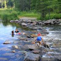 Children playing in the rapids at lake Itasca state park, Minnesota