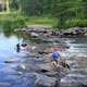 Children playing in the rapids at lake Itasca state park, Minnesota