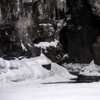 Water flowing out of the canyon with snow and ice in Temperance River State Park, Minnesota