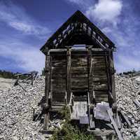Old Rustic Cabin under blue sky and clouds in Elkhorn, Montana