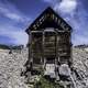 Old Rustic Cabin under blue sky and clouds in Elkhorn, Montana