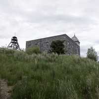 Fire tower and stone building perched on a hill in Helena