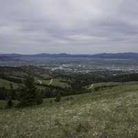 Helena and hill landscape with high mountains on the mountainside under grey skies