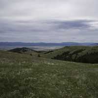 Overlapping hill landscape with mountains in the background in Helena