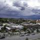 Town of Helena under heavy clouds with mountains in the background