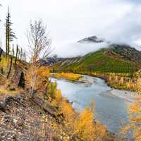 Autumn Stream with clouds covering the mountains