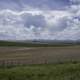 Clouds and farm landscape with town and mountains in Montana