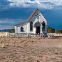 Women riding horse near a small church in Santa Fe, New Mexico