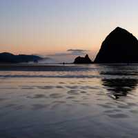 Silhouette of Large Rocks rising out of the Ocean at dusk in Oregon