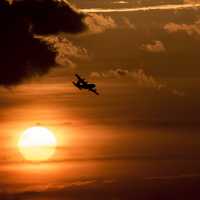 Aircraft flying over the sun during sunset over Charleston, South Carolina