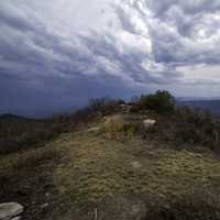 Mound at the Hilltop under lingering storm clouds at Sassafras Mountain, South Carolina