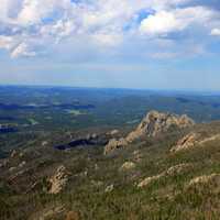 Forest and hills under the white clouds in Custer State Park, South Dakota