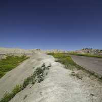 Road through the badlands to the horizon