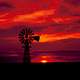 Windmill in the landscape with red skies in Texas