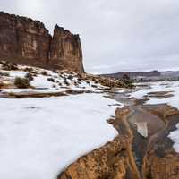 Slushy river landscape in the winter with snow in Arches National Park