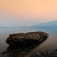 Rock in a foggy lake