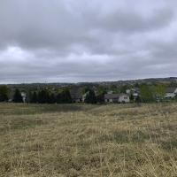 Dark clouds over houses and Ice Age Trail