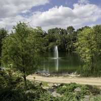 Landscape with pond and fountain in garden