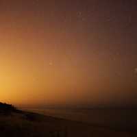 Stars in the red night skyat Kohler-Andrae State Park, Wisconsin