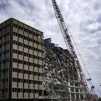 Building getting demolished by wrecking ball