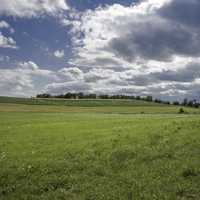 Farm and Fields under the sky and clouds