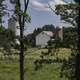 Farmhouse and Silo through the trees