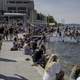 People sitting on the pier in front of the memorial union