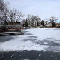 Sheet of ice and houses covering the harbor