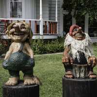 Two troll statues in front of a house in Mount Horeb