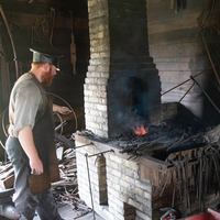 Blacksmith Heating Metal at Anvil