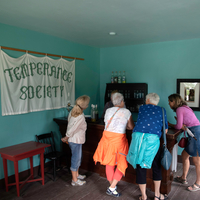 Group of visitors standing at the bar