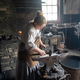 Metalworker hammering on the Anvil