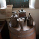 Tea Kettles on top of a Barrel