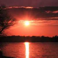 Red Sun over lake at Pike Lake State Park, Wisconsin