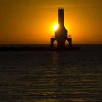 Sun behind the lighthouse at Port Washington, Wisconsin