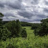 Heavy Clouds over the grassland and trees at Indian Lake County Park