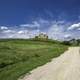 Path to abandoned homestead under blue skies