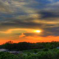 Orange sunset behind clouds in the distance in Southern Wisconsin