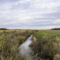 Stream landscape under the cloudy sky