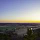 Sunset landscape with farmland and bluff