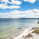 Shoreline landscape with lake with sky and clouds