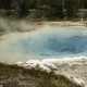 Steam rising from the blue waters of the spring