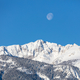 The moon above Electric peak after a winter storm