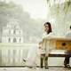 Couple sitting on a bench at Ho Guom at Hanoi, Vietnam