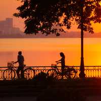 Sunset and 2 cyclists in Hanoi, Vietnam