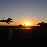Fighter jets landing at sunset